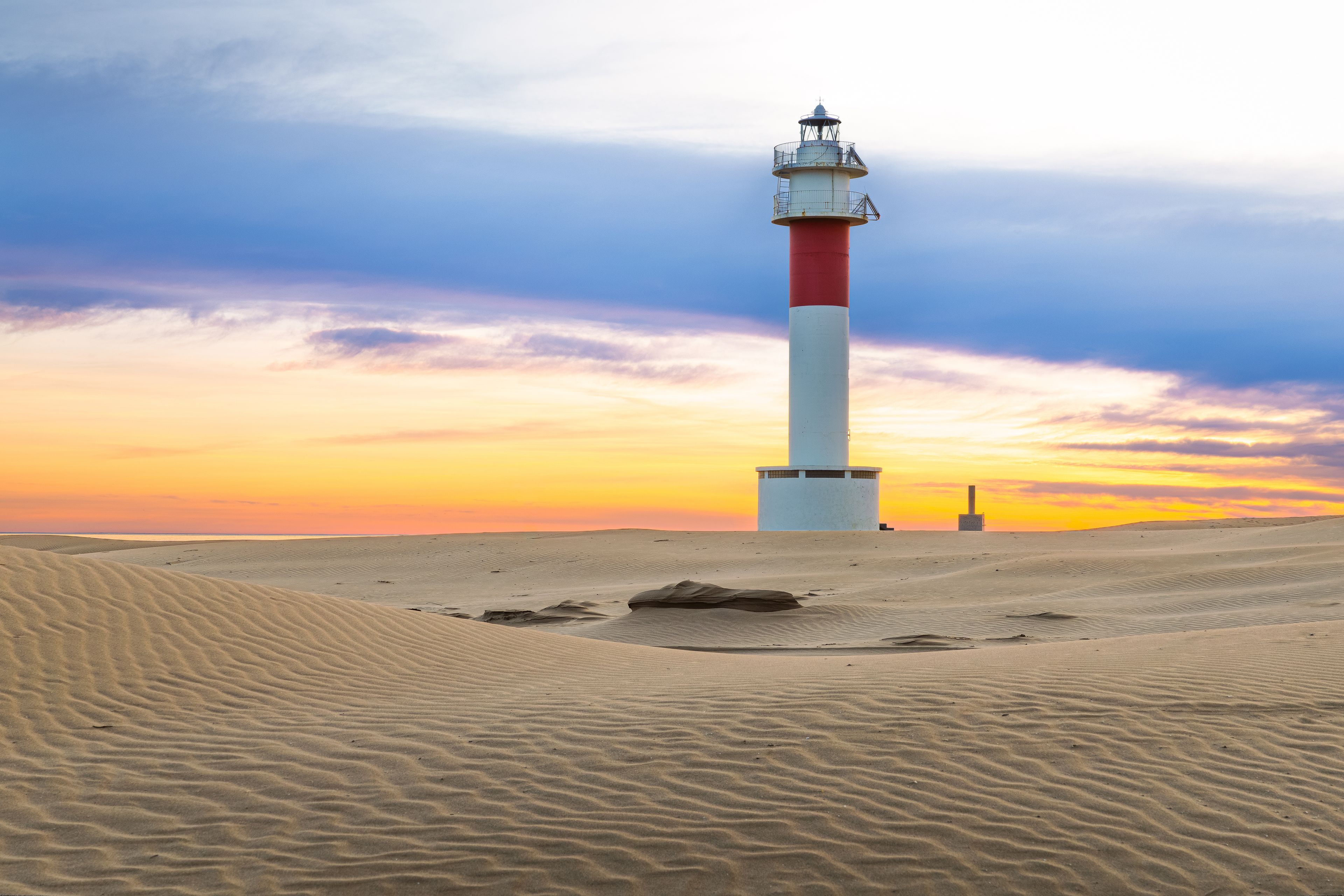 Fangar Lighthouse and Sand Dunes at Sunrise in Ebro Delta Natural Park, Spain
