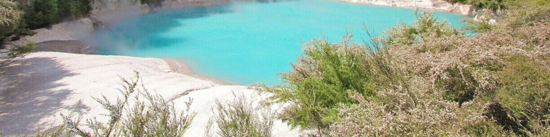 The Inferno Crater Lake is a hot spring lake located inside the Waimangu Valley reserve near Rotorua on New Zealand's North Island. Vivid blue and steaming, it's a really beautiful place to visit, and less popular than some of the other Rotorua attractions making it appealing to those looking for a quieter trip.