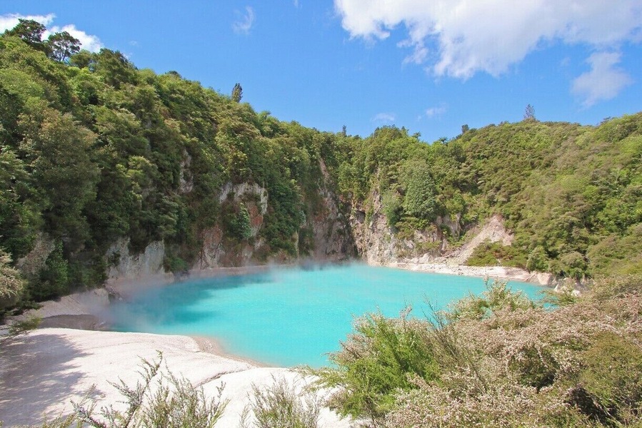 The Inferno Crater Lake is a hot spring lake located inside the Waimangu Valley reserve near Rotorua on New Zealand's North Island. Vivid blue and steaming, it's a really beautiful place to visit, and less popular than some of the other Rotorua attractions making it appealing to those looking for a quieter trip.