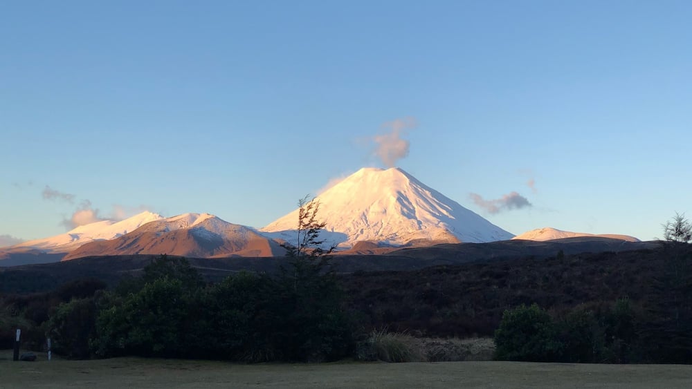 A snow-capped mountain with a clear sky.