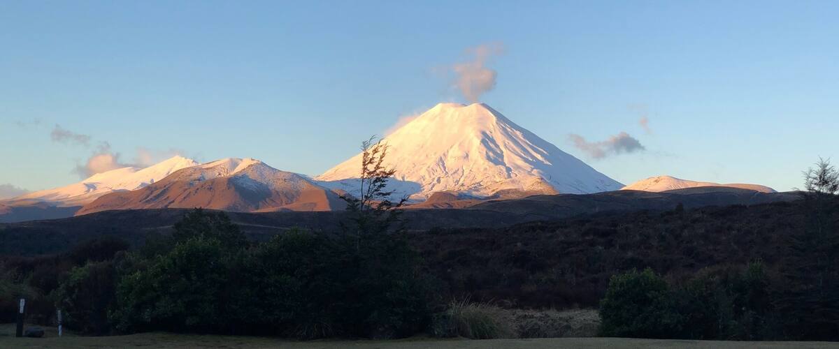 A snow-capped mountain with a clear sky.