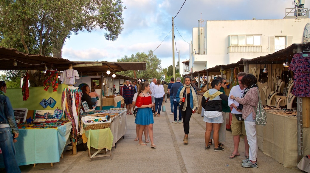 Pilar de la Mola featuring markets as well as a small group of people