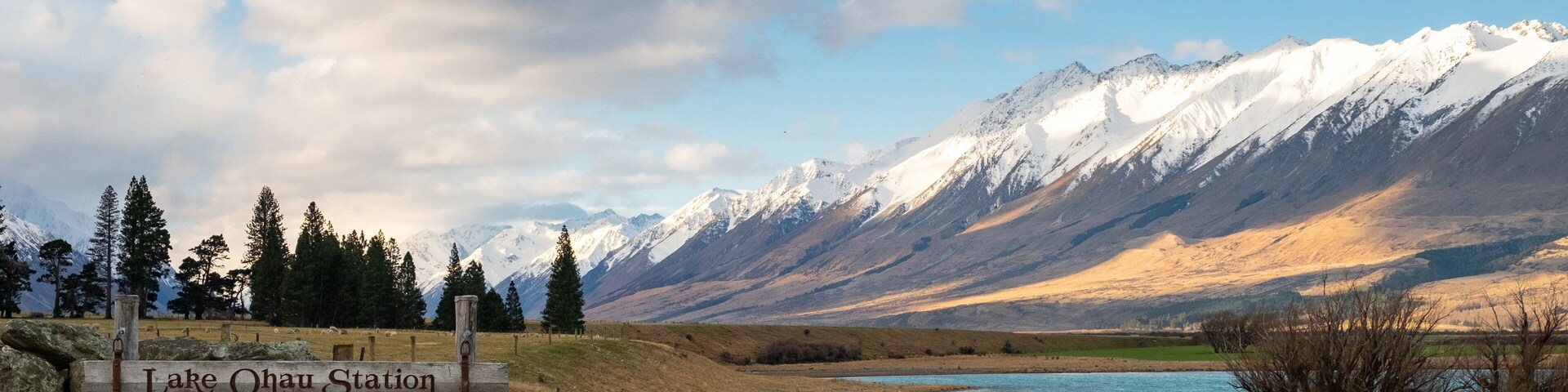 Ohau which includes mountains, signage and a lake or waterhole