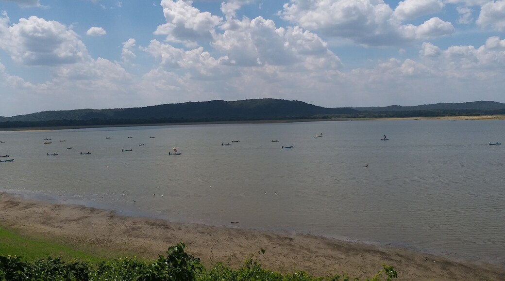 Fishermen set sail in their fishing boats at midday to cast their nets in the Kantale Tank