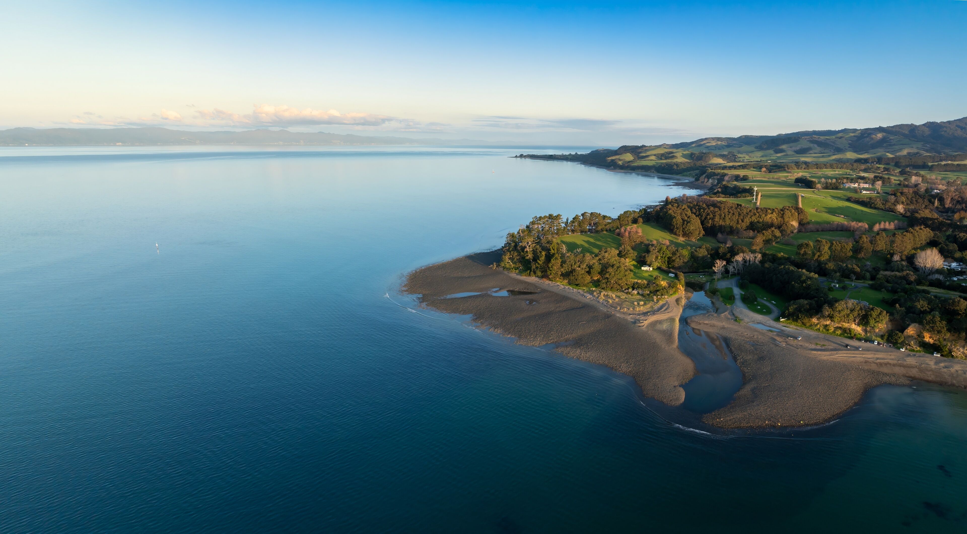 Shoreline of the Firth of Thames at sunset at Orere Point, Auckland, New Zealand.