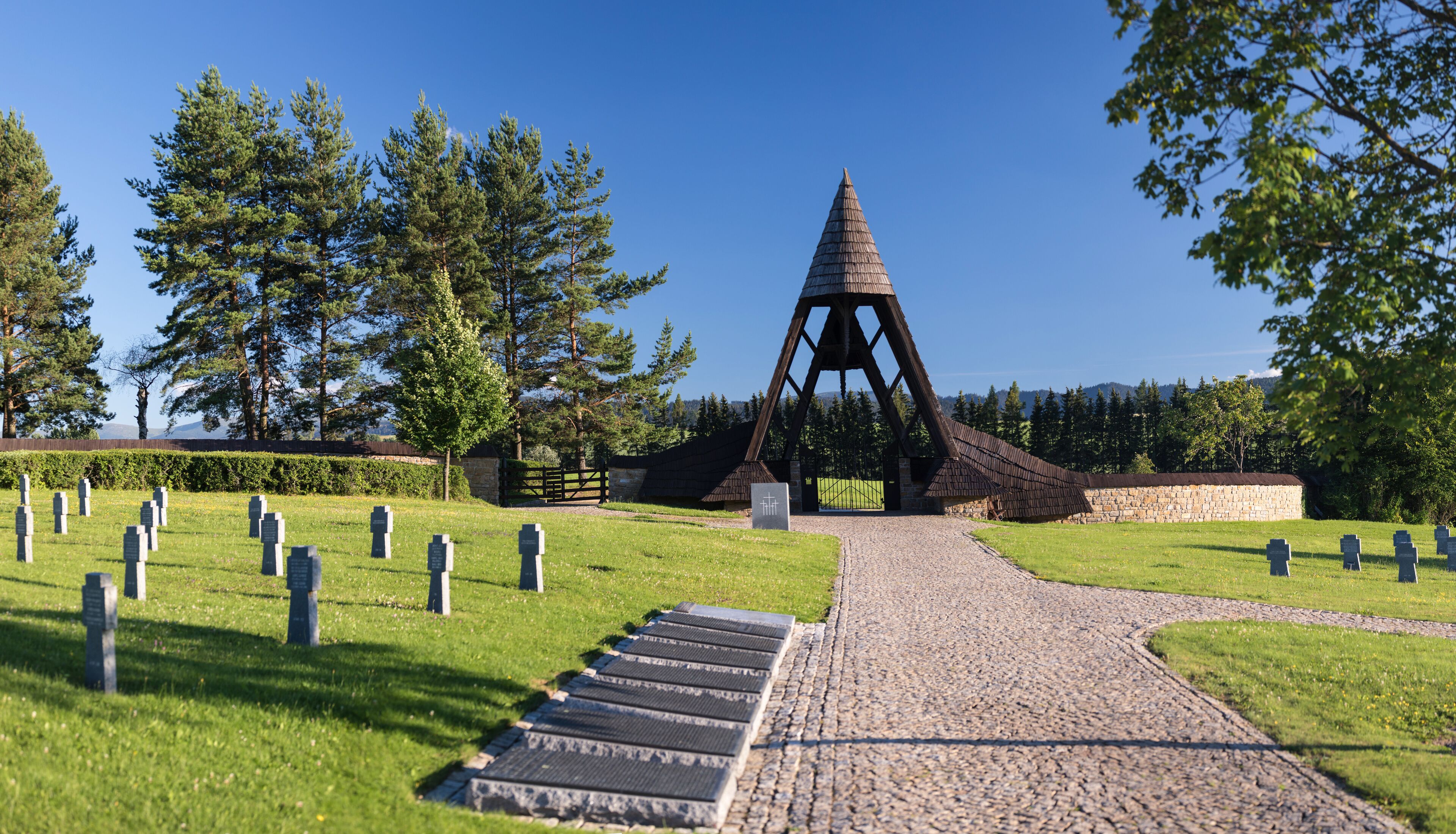 German military cemetery in autumn with mountains in the background and many graves of soldiers killed in the Second World War. Sunny day, Slovakia, Europe.