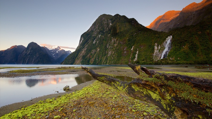 Fiordland National Park featuring mountains, a waterfall and a bay or harbour
