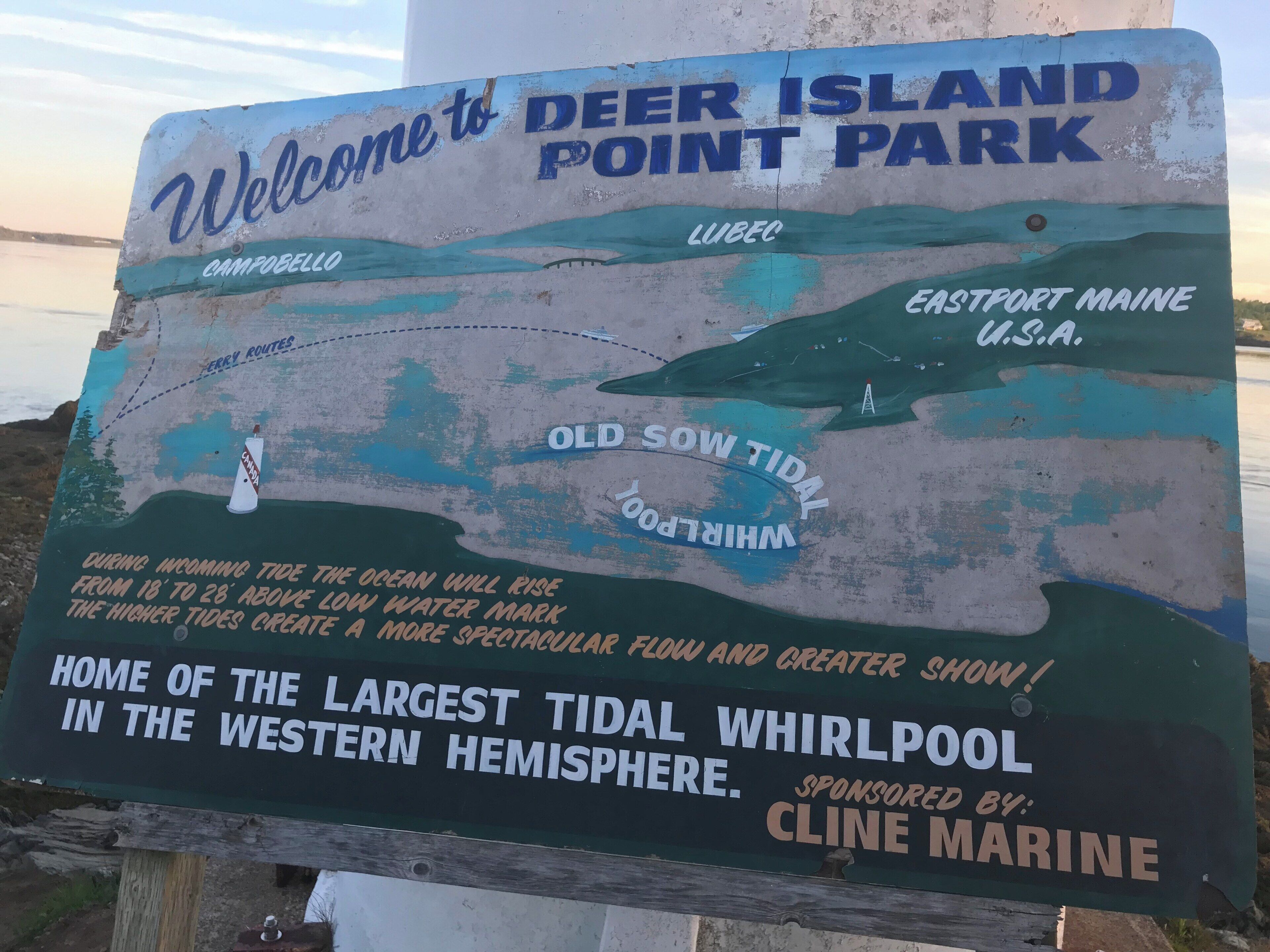 A sign welcoming visitors to Deer Island Point Park, mentioning the Old Sow Tidal Whirlpool and the largest tidal whirlpool in the western hemisphere.
