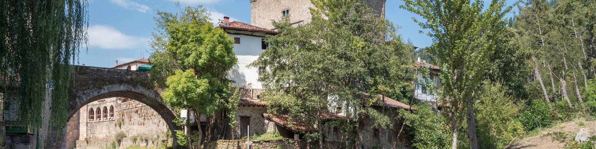 Old building near the bridge over the river in Potes, Cantabria, Spain