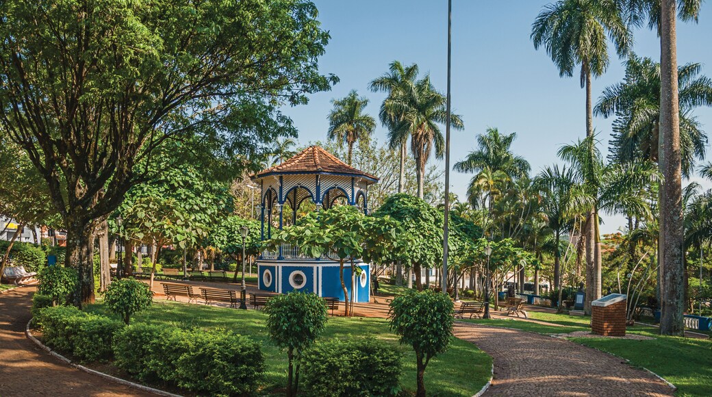 Close-up of old colorful gazebo amid verdant garden full of trees and sunshine at São Manuel. A cute little town in the countryside of São Paulo State. Southeast Brazil. Retouched photo.