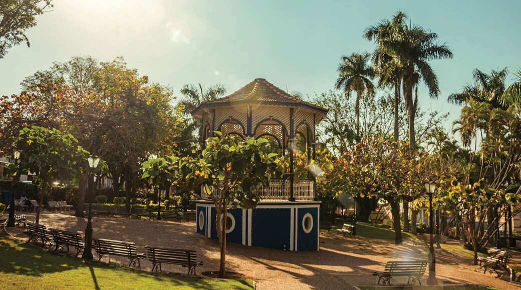 Old and colorful gazebo of square in the middle of verdant garden full of trees, in a bright sunny day at São Manuel. A cute little town in the countryside of São Paulo State. Southeast Brazil.