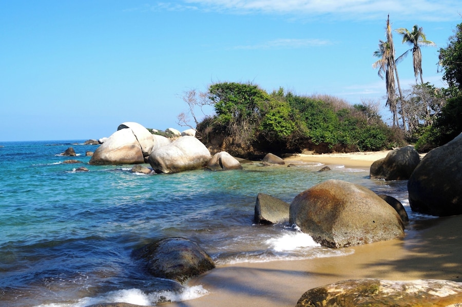 One of the beautiful beaches of Tayrona National Park in Colombia. You can hike from the National Park entrance to the beaches and stay overnight in a hammock.