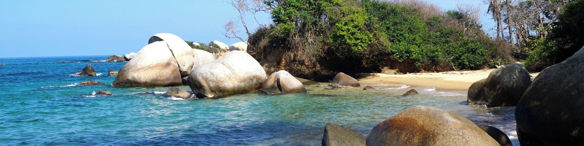 One of the beautiful beaches of Tayrona National Park in Colombia. You can hike from the National Park entrance to the beaches and stay overnight in a hammock.