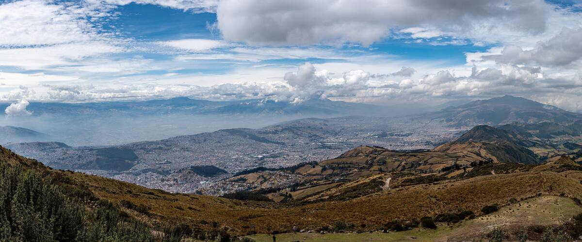 A mountainous landscape with a city in the valley below.