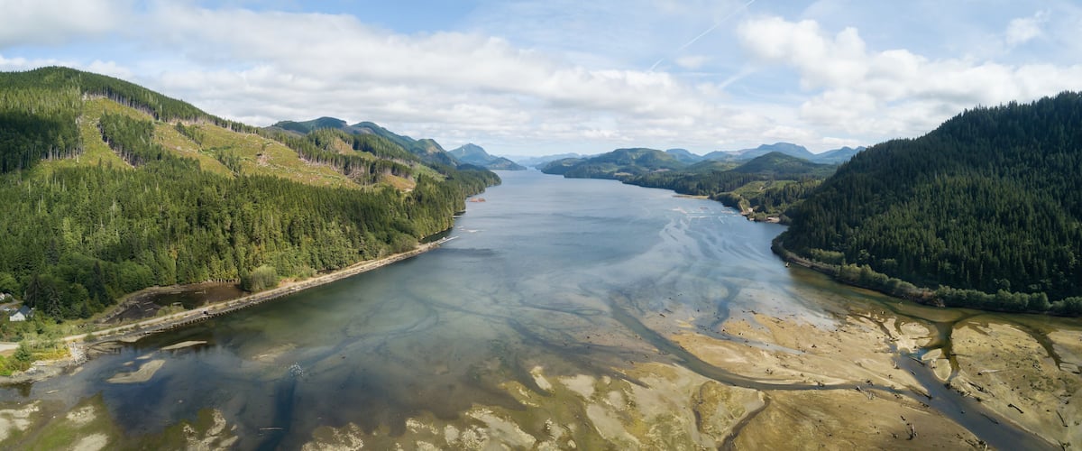 A river winding through a forested valley with hills on either side.