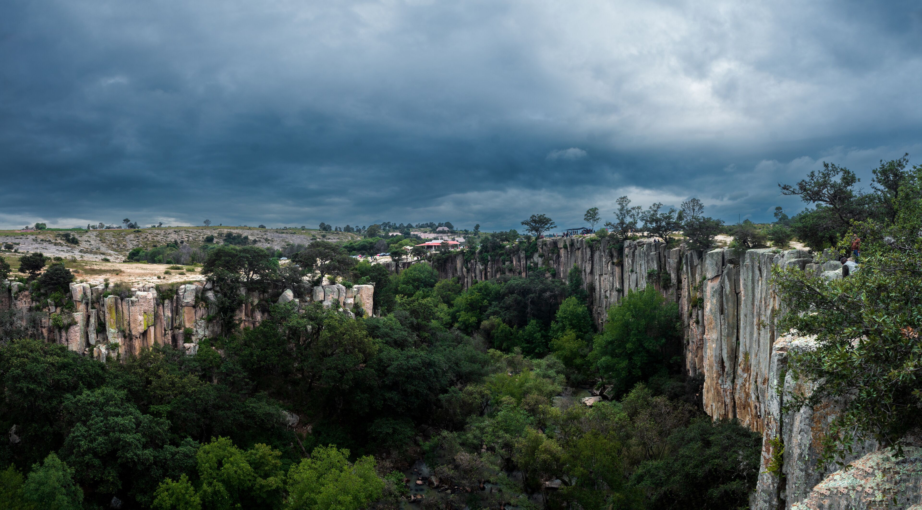 A rugged landscape with towering rock formations and dense greenery.
