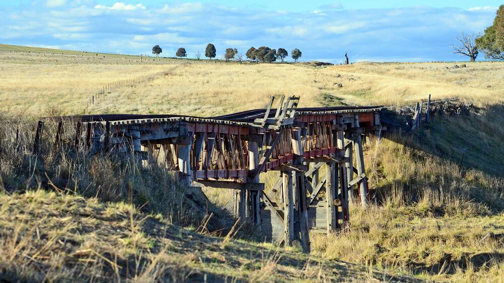 Old abandoned wooden railway bridge over the Boorowa River, in rural central west NSW, Australia