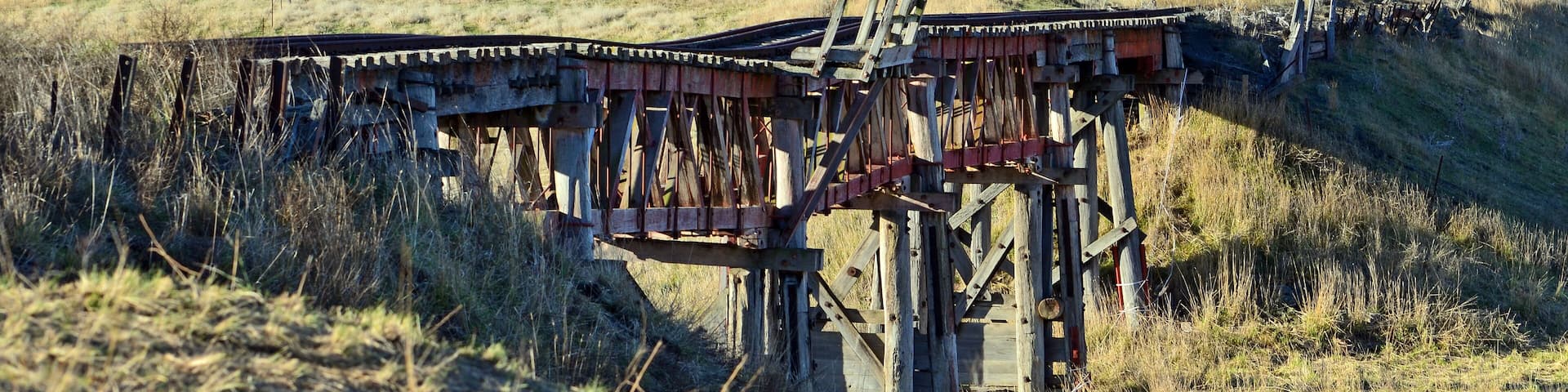 Old abandoned wooden railway bridge over the Boorowa River, in rural central west NSW, Australia