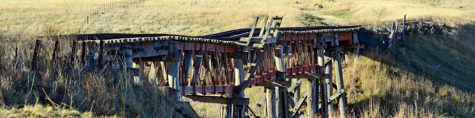 Old abandoned wooden railway bridge over the Boorowa River, in rural central west NSW, Australia