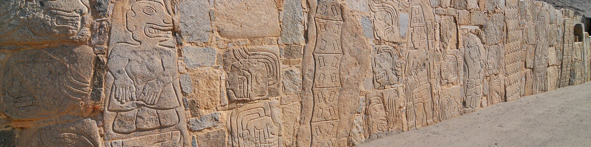 A stone wall with ancient carvings.