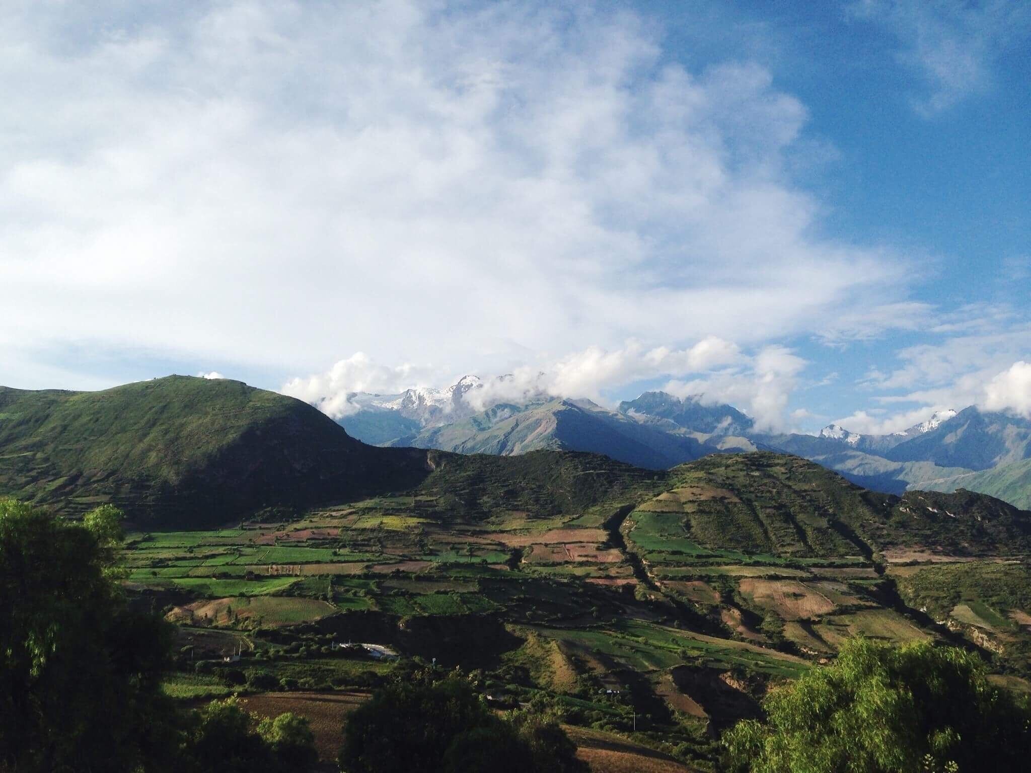 A mountainous landscape with terraced fields and a clear sky.
