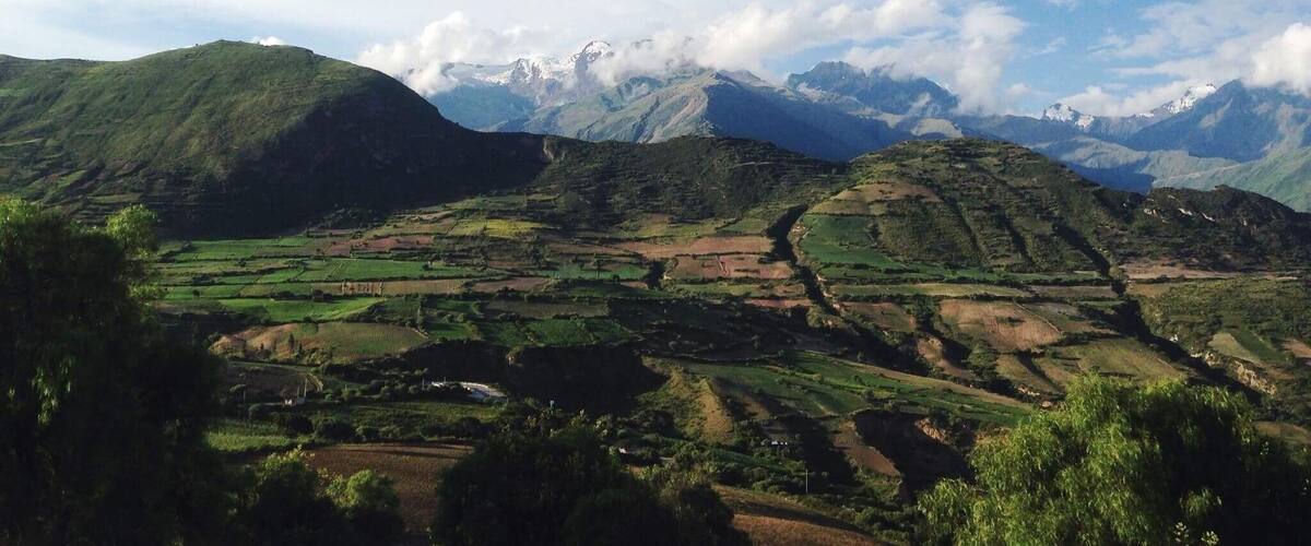 A mountainous landscape with terraced fields and a clear sky.
