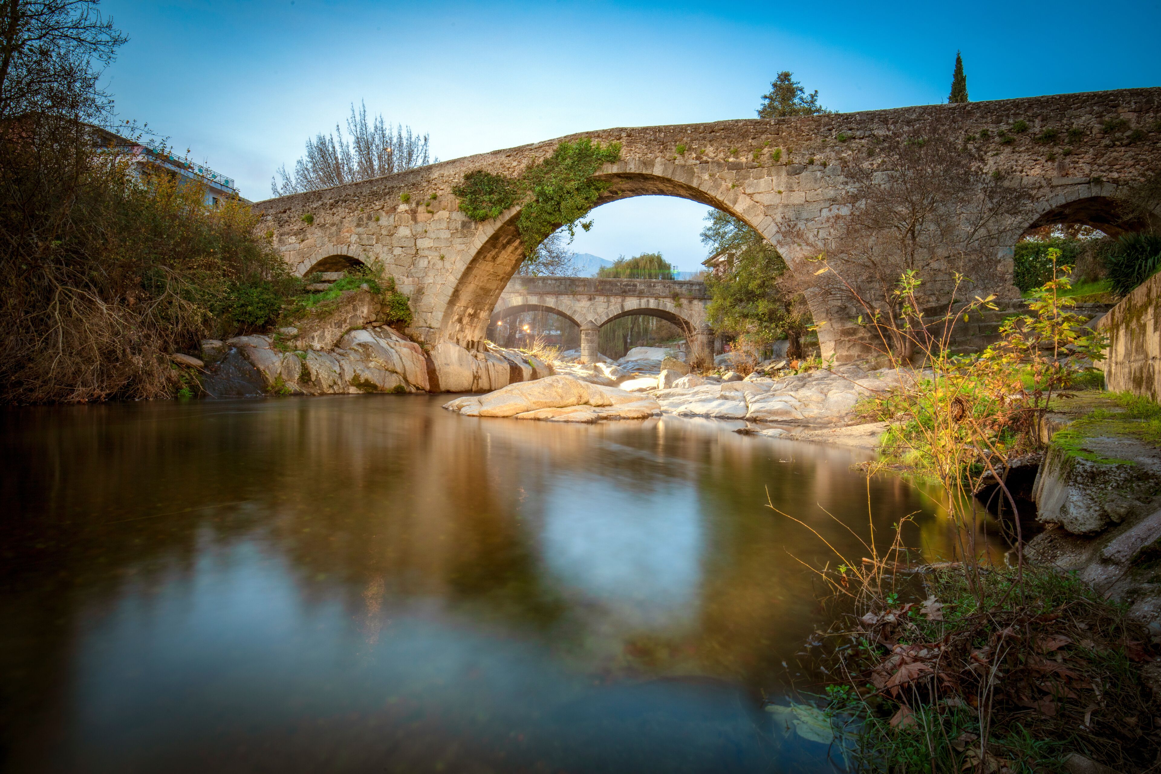 View of the medieval Aquelcabos bridge over the Arenal river in Arenas de San Pedro, Avila, Castilla y Leon, Spain, in the afternoon