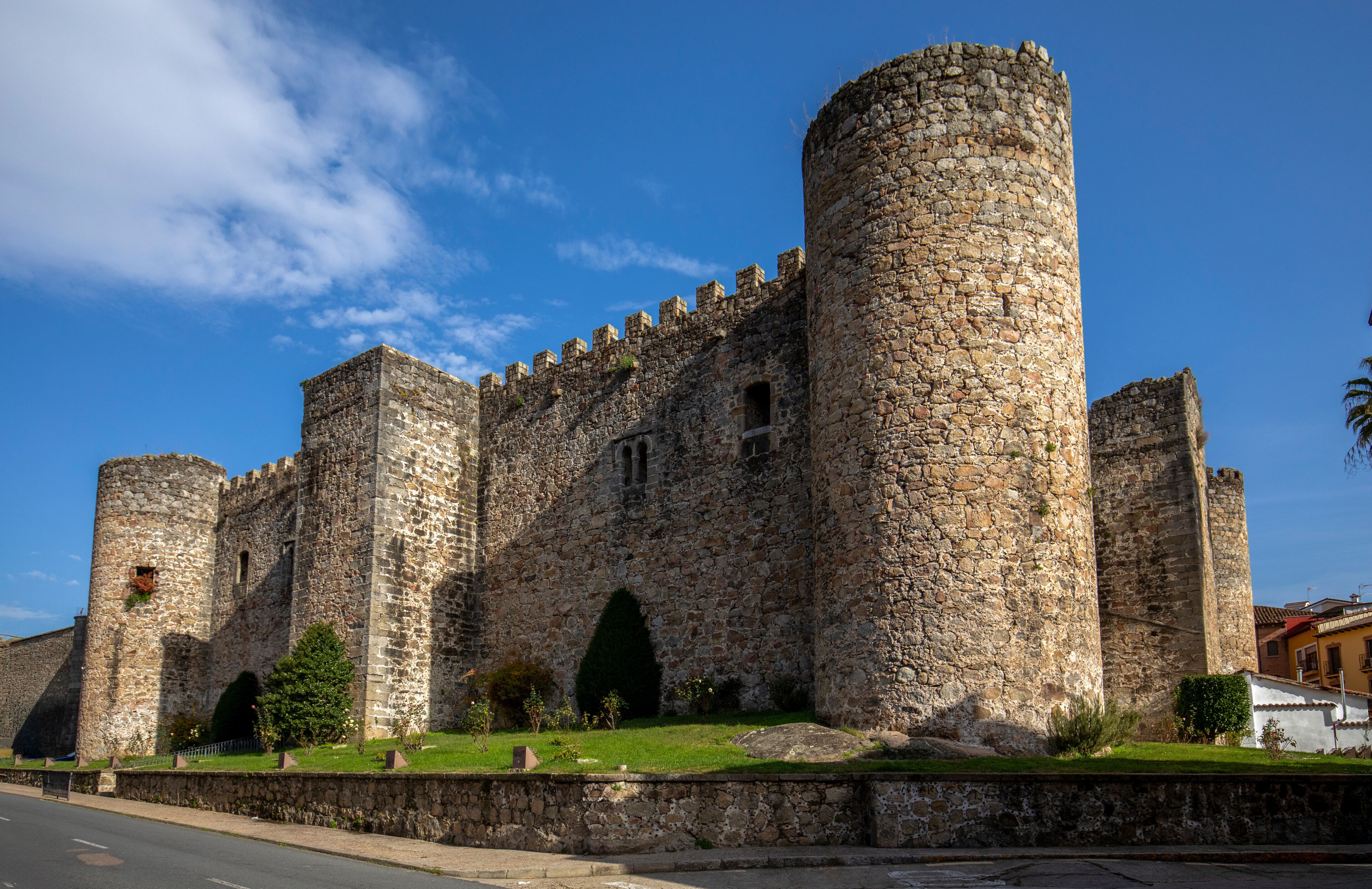A historic stone castle with multiple towers and arched windows.