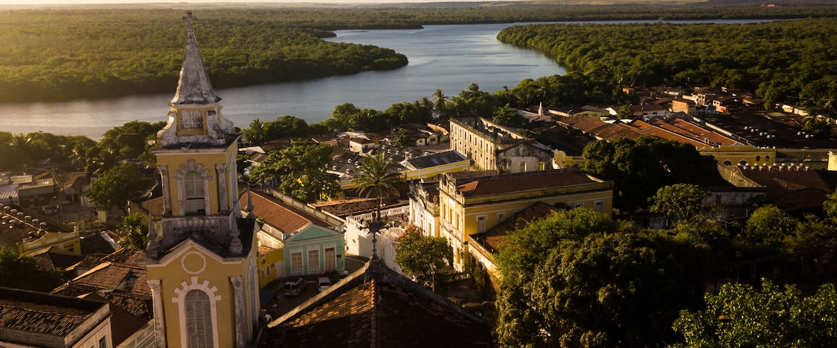 A river winding through a town with historic buildings and a prominent church steeple.