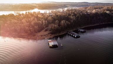 Bass fishermen fishing around dock on table rock lake during the winter