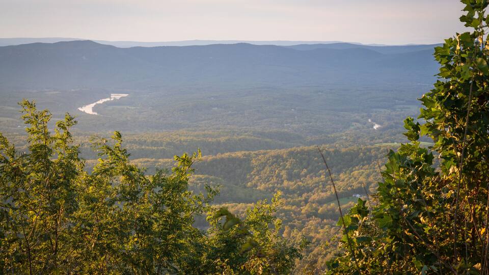 A mountainous landscape with a river winding through the valley.