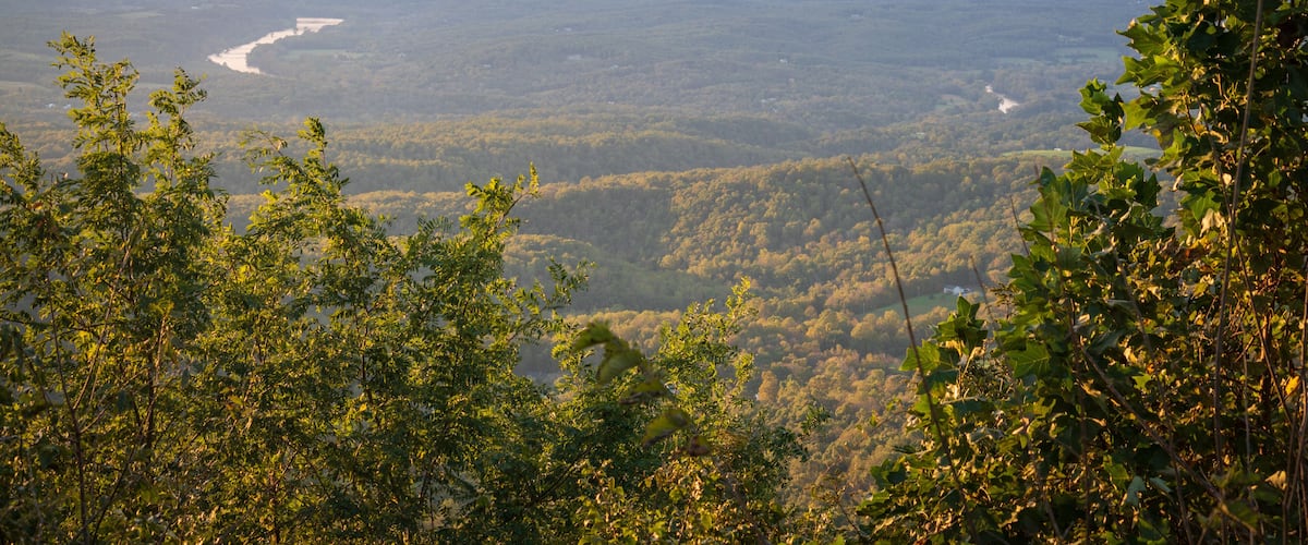 A mountainous landscape with a river winding through the valley.