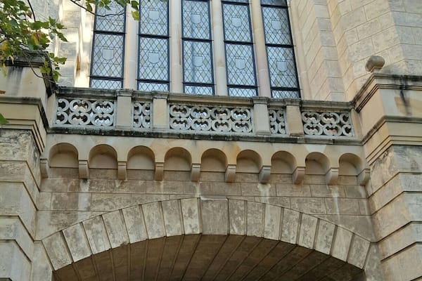 A very European archway at the University of Western Australia, with very Australian bushes beyond!