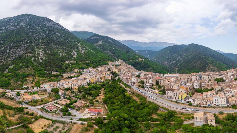 A town nestled in a valley surrounded by mountains.
