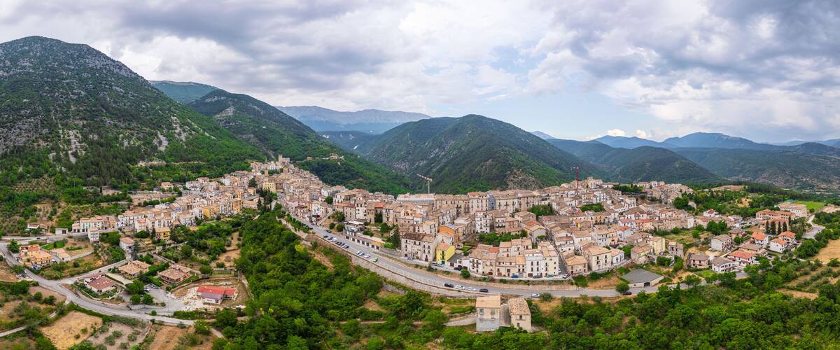 A town nestled in a valley surrounded by mountains.