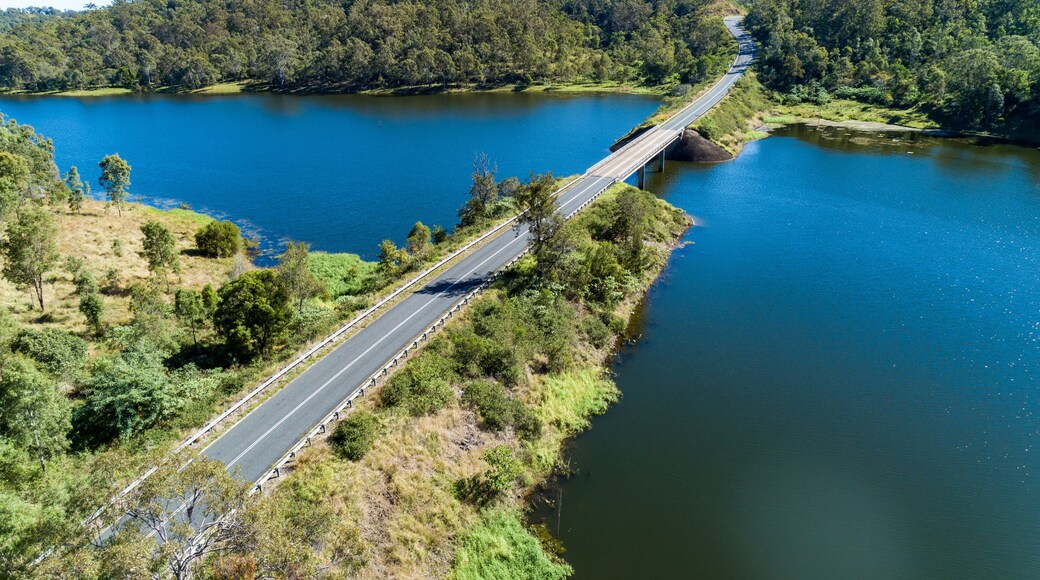 Aerial view of bridge and road crossing a lake.