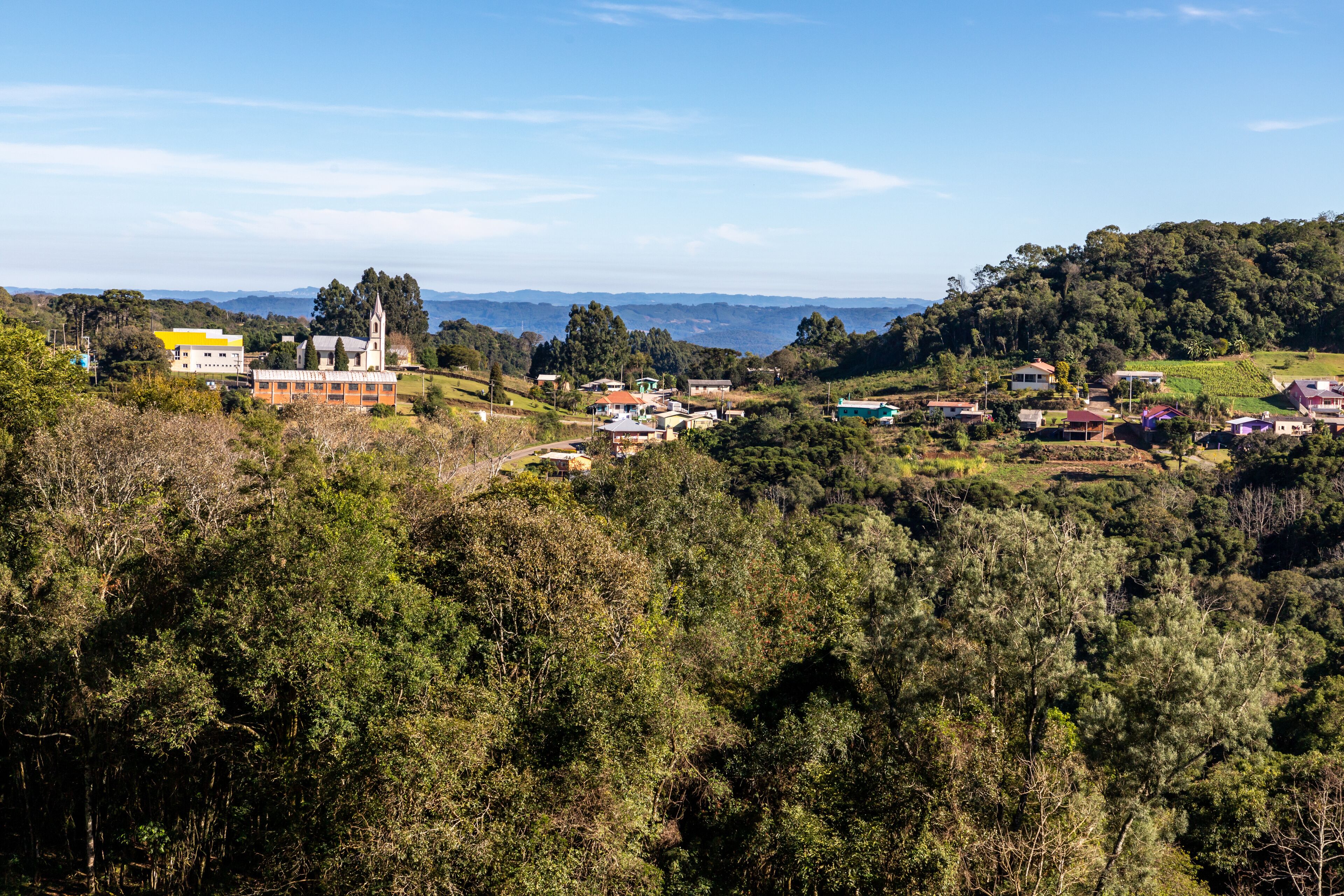 A town nestled in a valley with a prominent church and residential buildings.