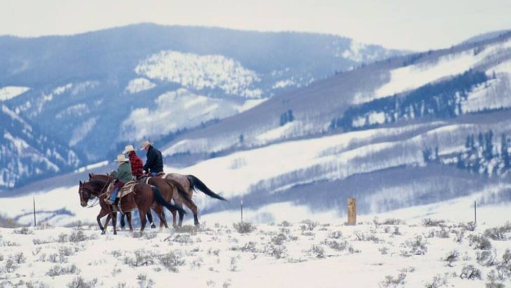 Family Horseback Riding in the Snow