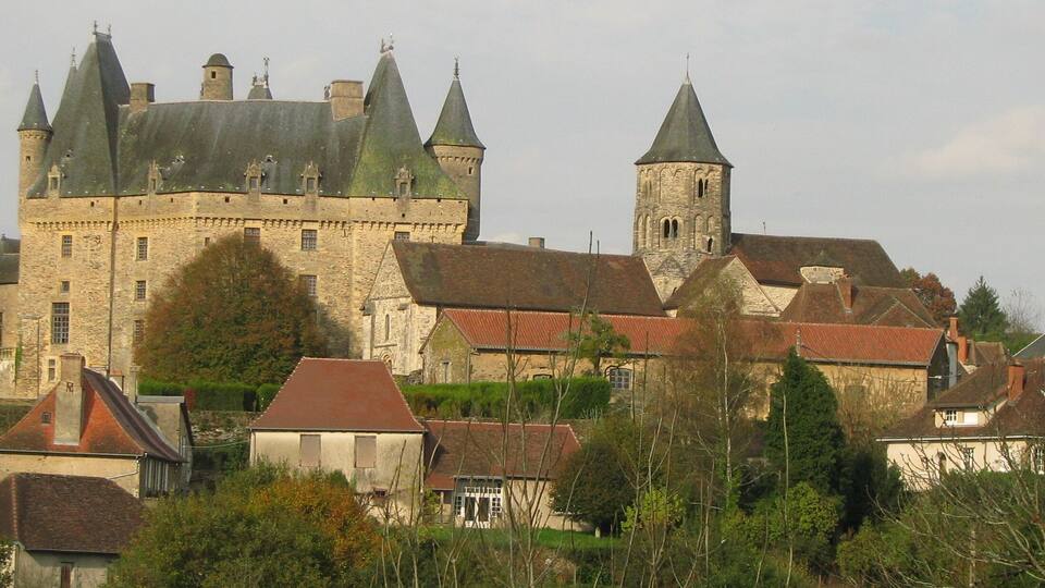 A historic castle with multiple towers and a prominent church.