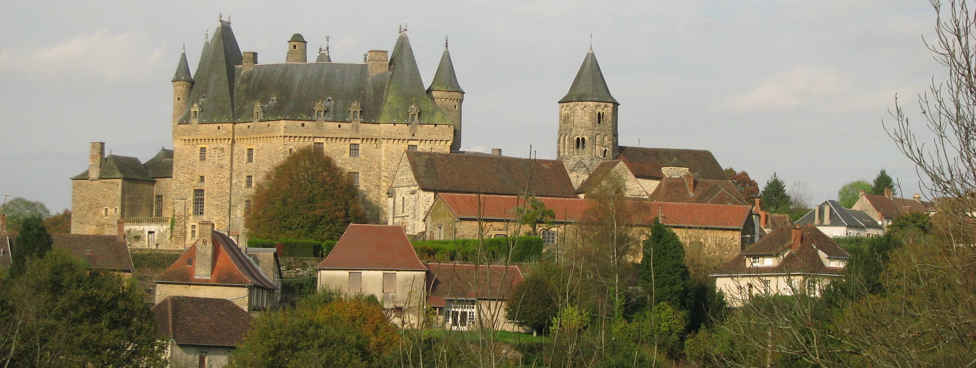 A historic castle with multiple towers and a prominent church.