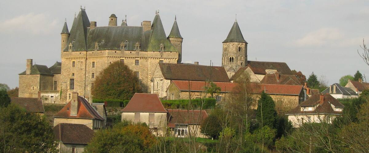 A historic castle with multiple towers and a prominent church.