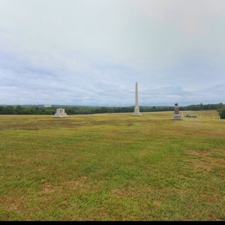 You are looking at what would be the main body of the prison, now just a field. This field has monuments thought along with a museum on the north lawn and information everywhere that gives insight to the living conditions, history, and representation of where the walls were originally. This place is eerily unique and gives an amazing account of our country's sometimes pained past.

Possibly the worst prison of the Civil war. The prison, which opened in February 1864, originally covered about 16.5 acres of land enclosed by a 15-foot high stockade. In June 1864 it was enlarged to 26.5 acres. The stockade was in the shape of a rectangle 1,620 feet by 779 feet. 
 
At Andersonville, a light fence known as "the dead line" was erected approximately 19 feet inside the stockade wall. It demarcated a no-man's land that kept prisoners away from the stockade wall, which was made of rough-hewn logs about 16 feet high. As was the similar fate facing Confederate prisoners in Northern camps which employed the same "dead line" fence, anyone crossing or even touching this line was shot without further command of any kind by sentries located in the pigeon roosts.