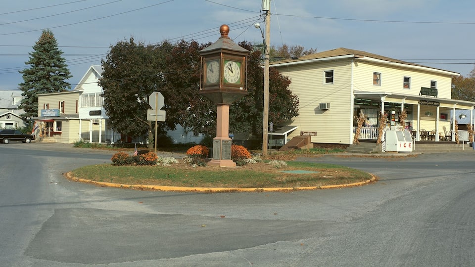 A town square with a clock tower, a gazebo, and a building labeled 'Ice'.