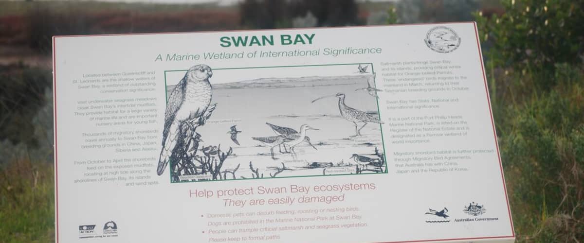 A signboard about Swan Bay, a marine wetland of international significance.