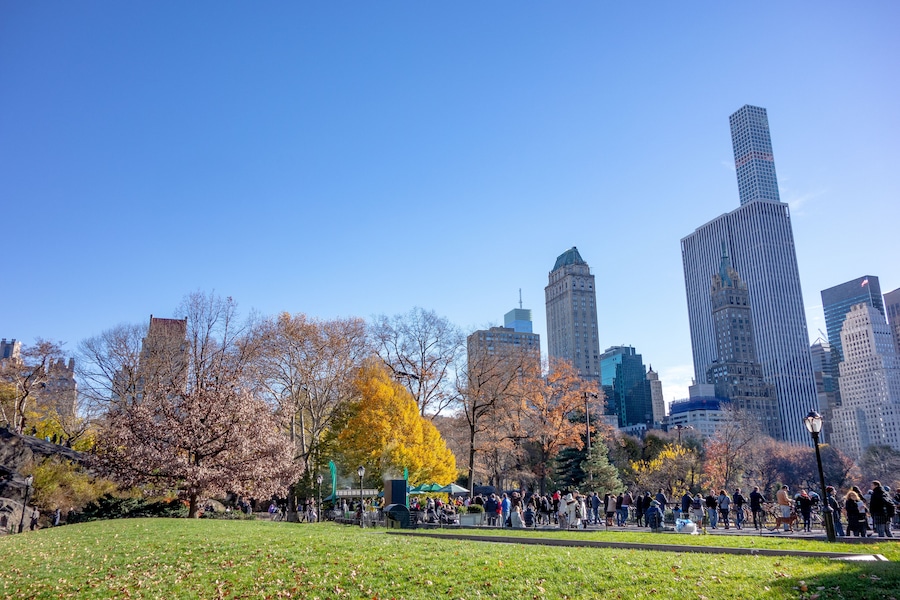 New York, NY, USA - November, 8, 2015: Fall Autumn time in Central Park. Fallen Leaves. People walking with kids and enjoying beautiful season of bright colors and warm weather.