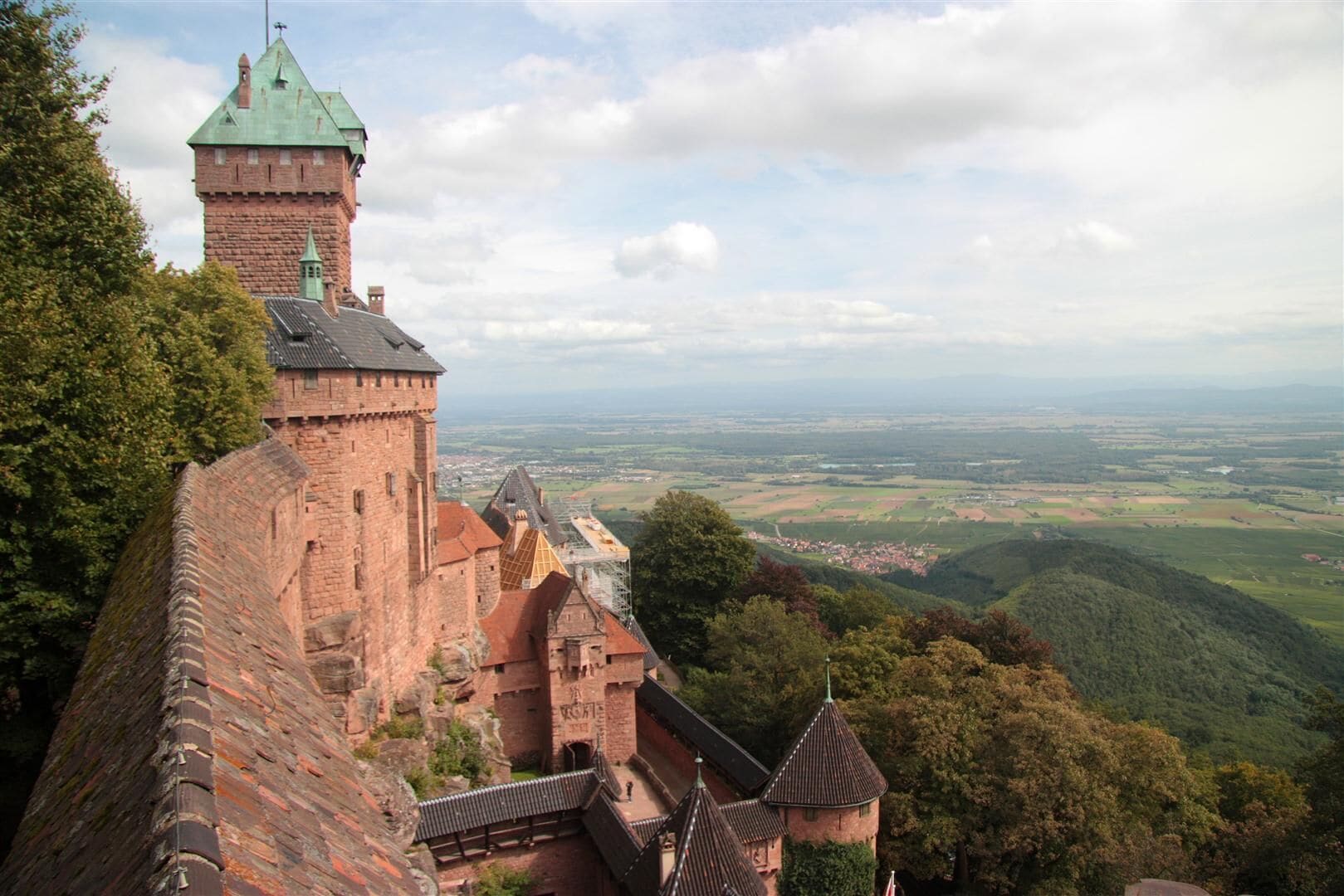 A historic castle with a prominent tower and a panoramic view of the surrounding countryside.