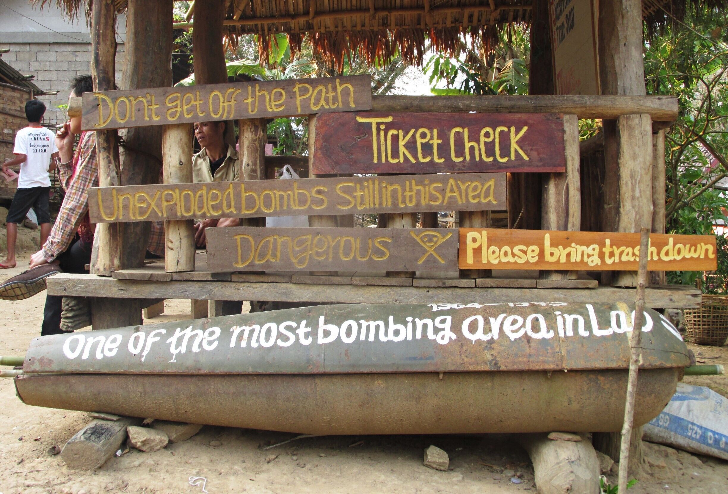 Signs at the beginning of the hike to the viewpoint overlooking Nong Kiaow in northern Laos.  You will be greeted here with a bottle of water and a firm warning not to stray from the trail.

Laos has the distinction of being the most heavily bombed nation in the world.  Between 1964 and 1973, the US dropped an estimated 250 million cluster bombs- about 2.5 million tons- here in an effort to thwart the forward movement of the North Vietnamese Army.  Many of these did not explode, and of those remaining only a tiny fraction have been destroyed.  Since the bombing ceased, over 20,000 people have been killed or injured by these UXO's (unexploded ordnances), and hundreds more die each year.  In addition to claiming lives, these devices destroy large portions of farmland or render them unusable. 

Despite all of this, I found the Laotian people to be among the friendliest and most generous that I have met on my travels, even as some recount stories of loved ones who have lost their lives or limbs to UXO's.  The natural beauty of the country brought me here, but it's the people that will keep me coming back.

#laos #nongkiaow 