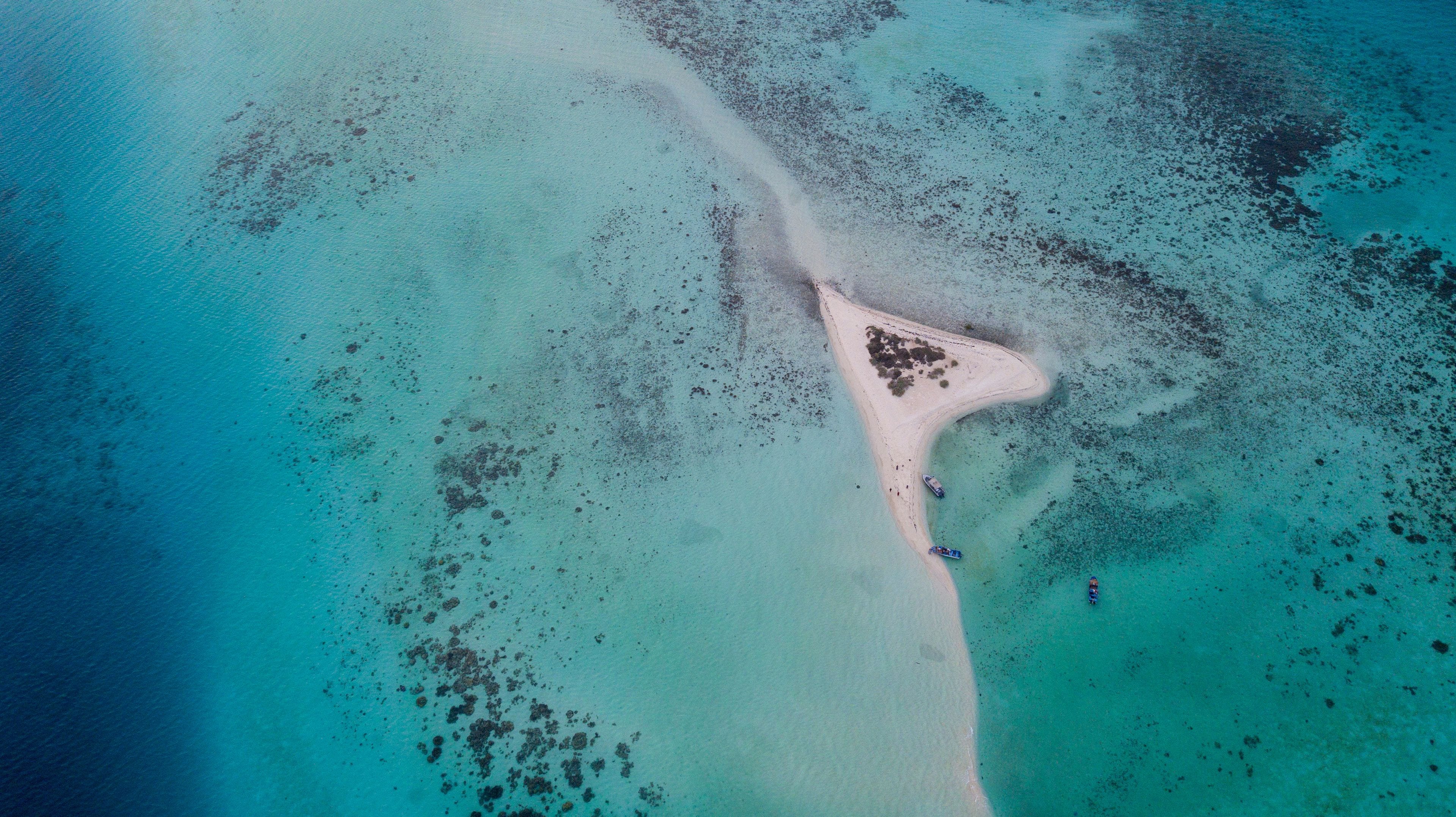Top Down Aerial Drone View of a Romantic Heart-Shaped Island Surrounded by Turquoise Coral Reefs in the Red Sea Saudi Arabia