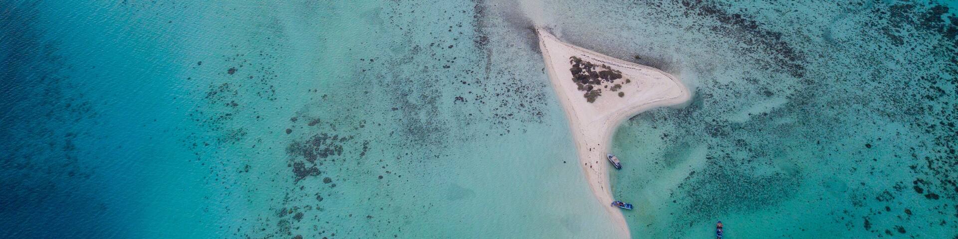 Top Down Aerial Drone View of a Romantic Heart-Shaped Island Surrounded by Turquoise Coral Reefs in the Red Sea Saudi Arabia
