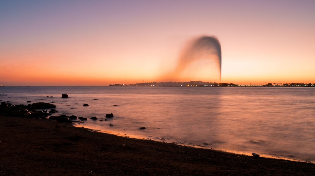 Panoramic view of the King Fahd's Fountain seen from the South Corniche, Jeddah, Saudi Arabia, with a beautiful sunset in the background
